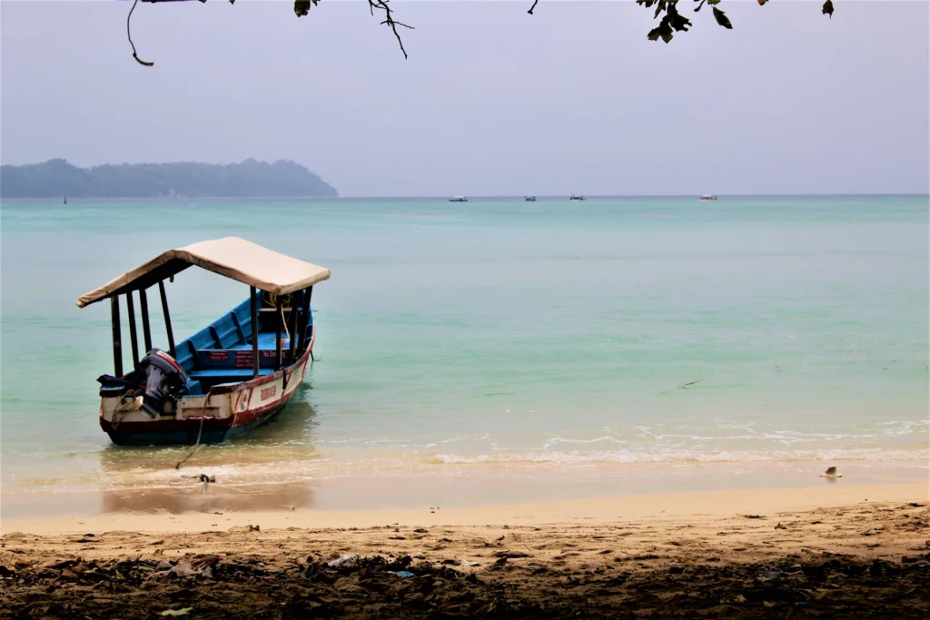 Best Time to Visit Andaman: A Month-by-Month Guide 3 A small boat at the water's edge on an Andaman beach