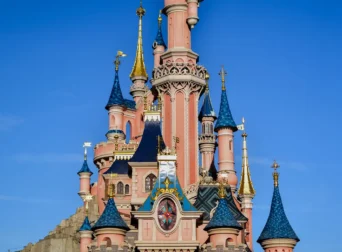Sleeping Beauty Castle at Disneyland Paris under a blue sky