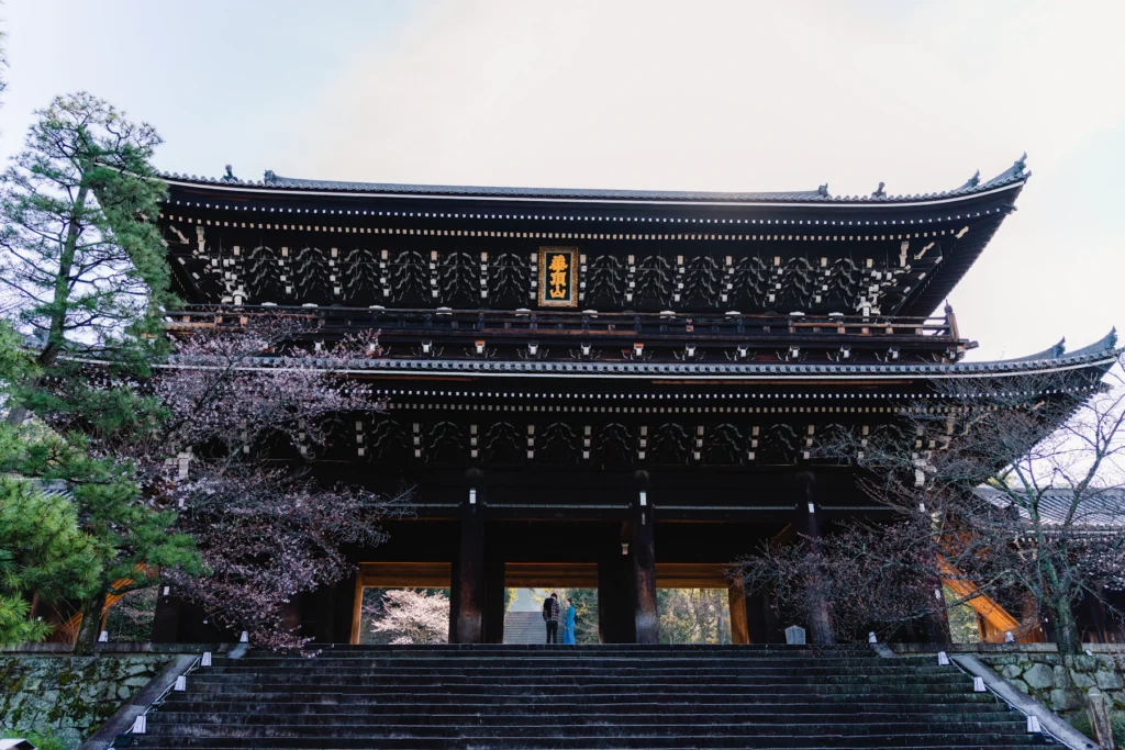 Best Time to Visit Japan from India: Cherry Blossom, Autumn and Snow 2 Cherry blossom beside a wooden temple gate in Japan