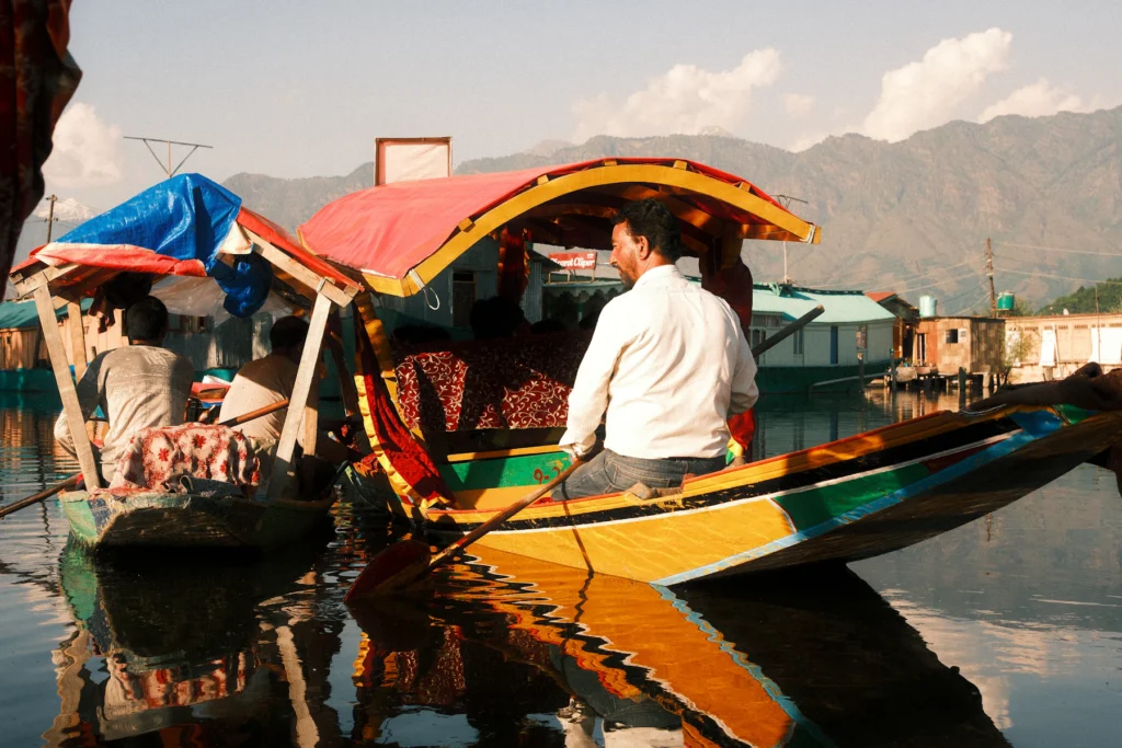 Kashmir Trip Cost from India (2026–27): What a 7-Day Trip Really Costs a Couple 1 A boatman in a painted shikara on Dal Lake in Srinagar