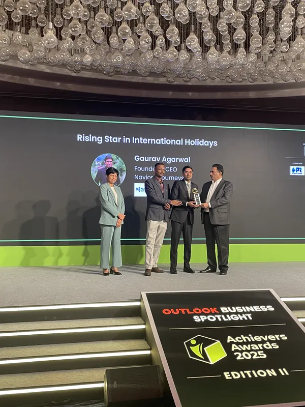 Gaurav Agarwal of Naviora Journeys receiving the Rising Star in International Holidays award on stage at the Outlook Business Spotlight Achievers Awards 2025